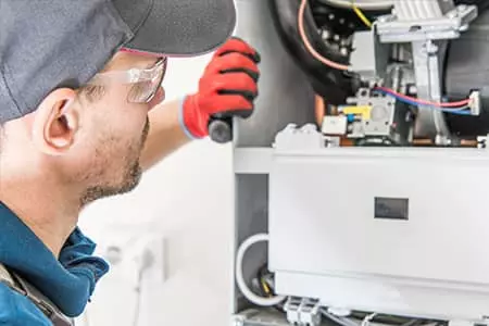 A man performing commercial hvac maintenance.