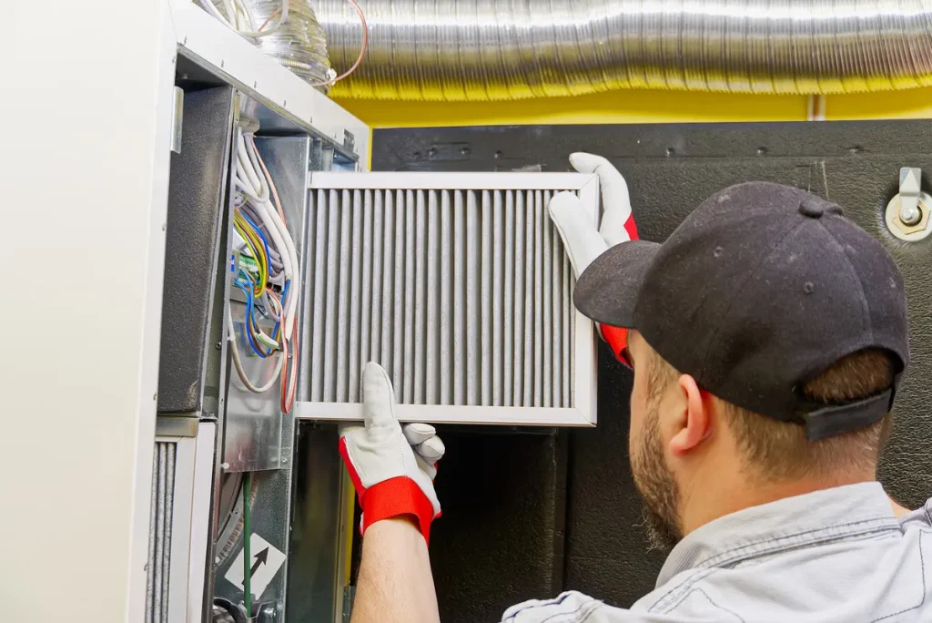 An HVAC technician performing a new heating installation in El Paso.
